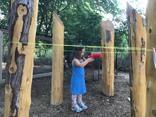 Child moving cup on string