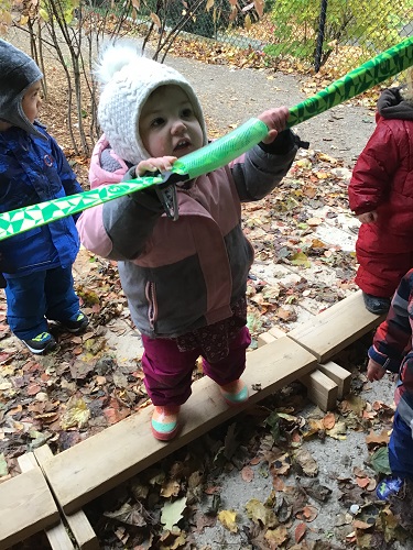 child hanging on and balancing