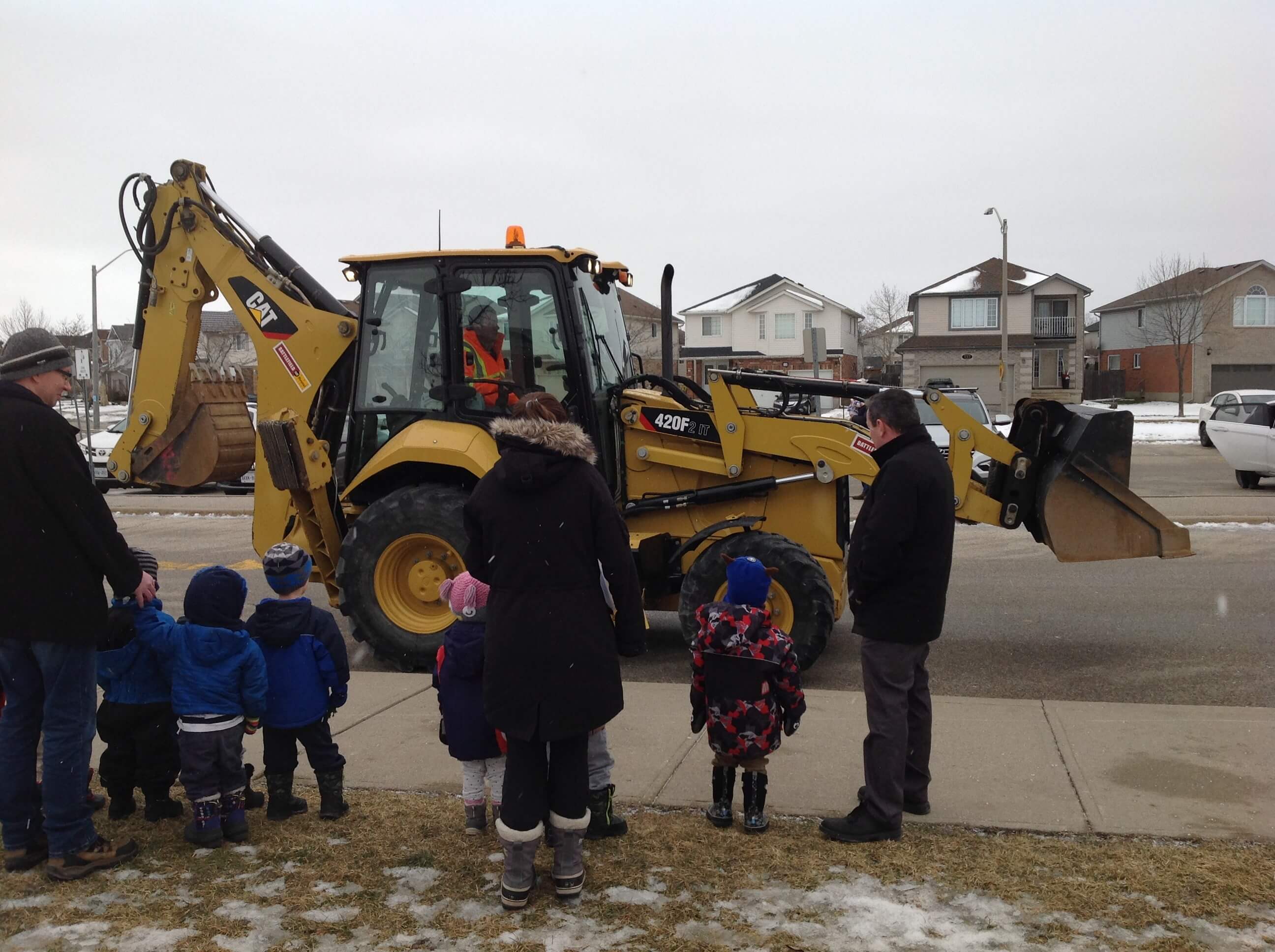 children watching a real digger