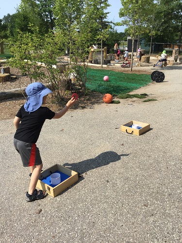 Preschool boy throwing washer in game