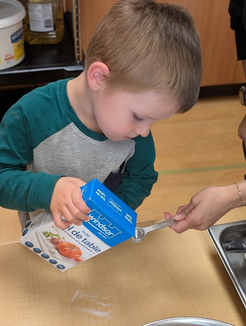 child pouring in the salt