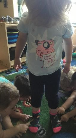 children pointing to girls socks