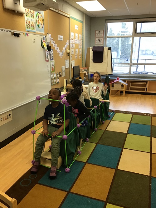 Children sitting in their created bus.