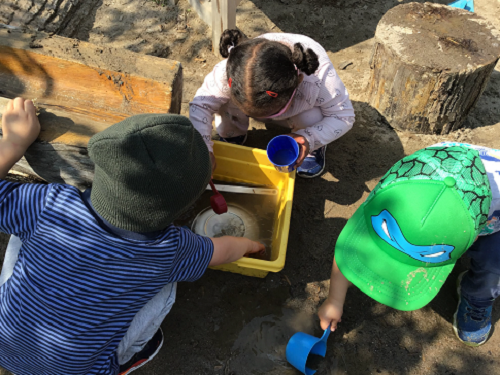 Children exploring in sandbox.