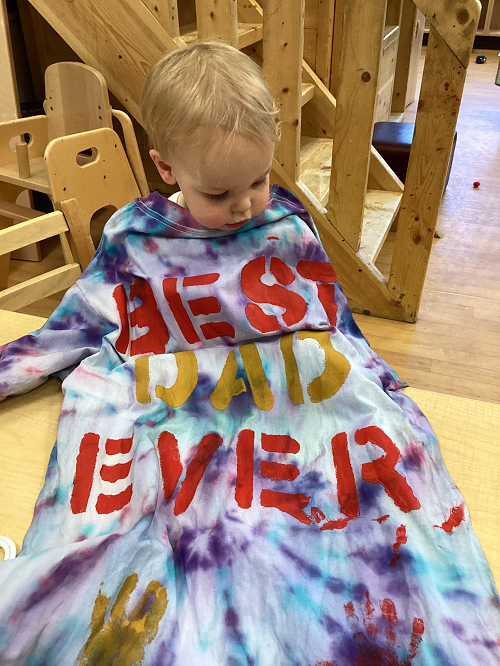 Child observing the colours on their shirt.