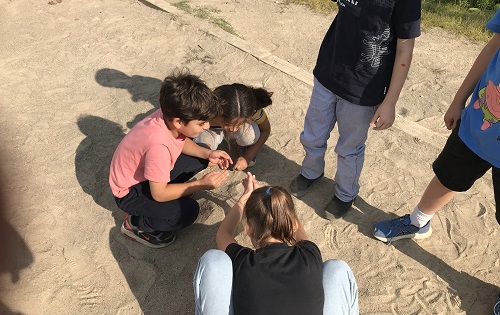 Children exploring in the sand box.
