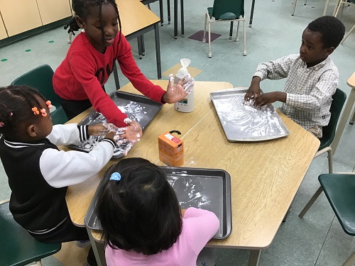 Children exploring baking soda and conditioner.