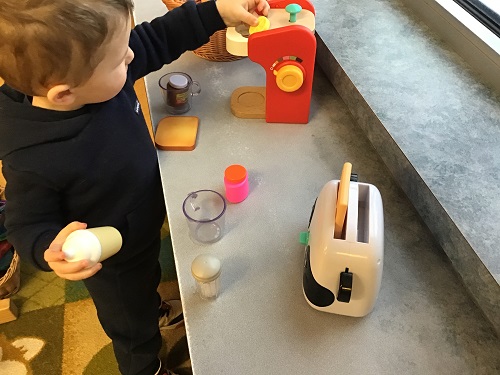 Child pretending to make coffee.