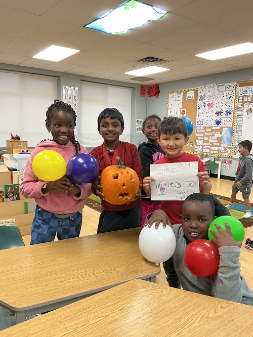 Group showing their completed pumpkin.