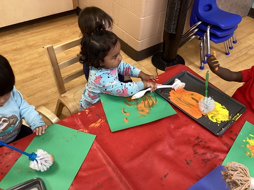 Children painting with different types of brushes