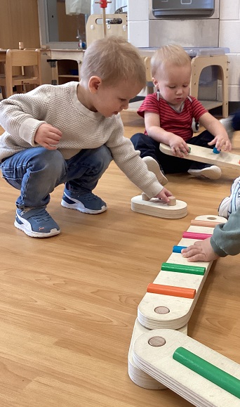 Children exploring with a balance beam.