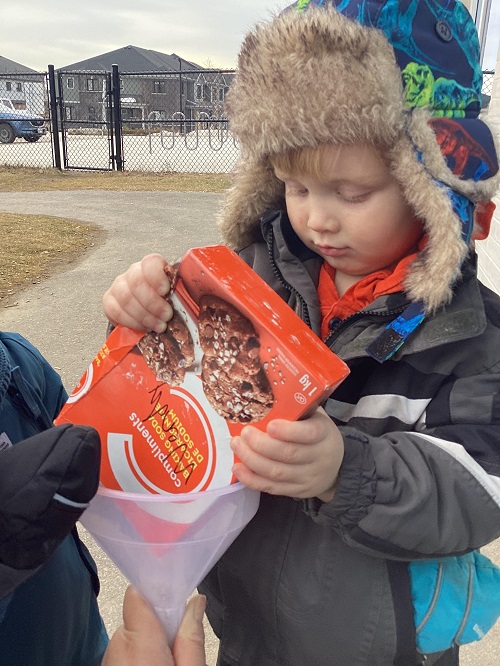 A child pouring baking soda into a bag