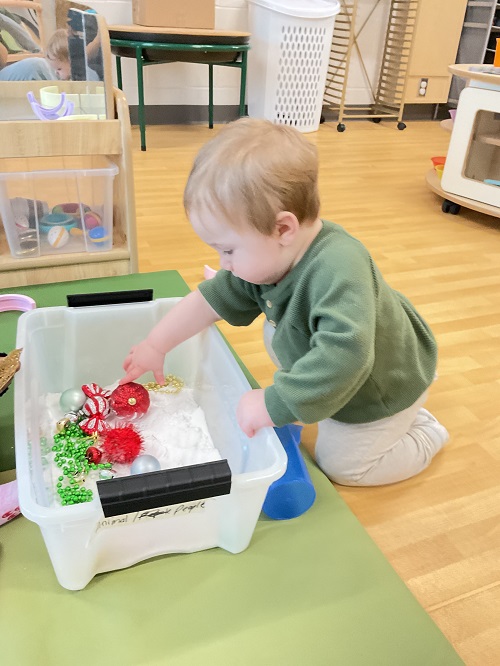 child in sensory bin