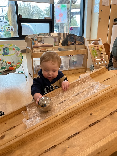 child with mirror ball on ramp