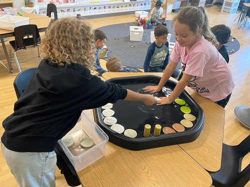 2 children in tuff tray