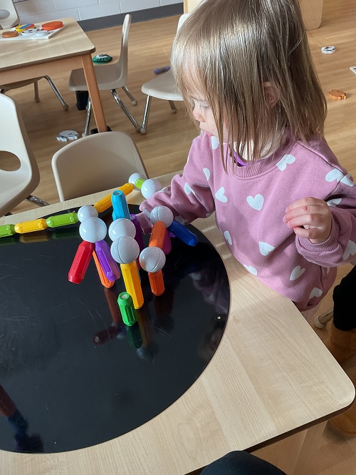 child creating a magnetic scultpure