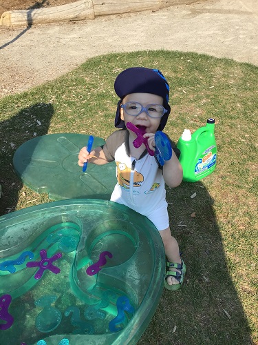 an infant playing in water